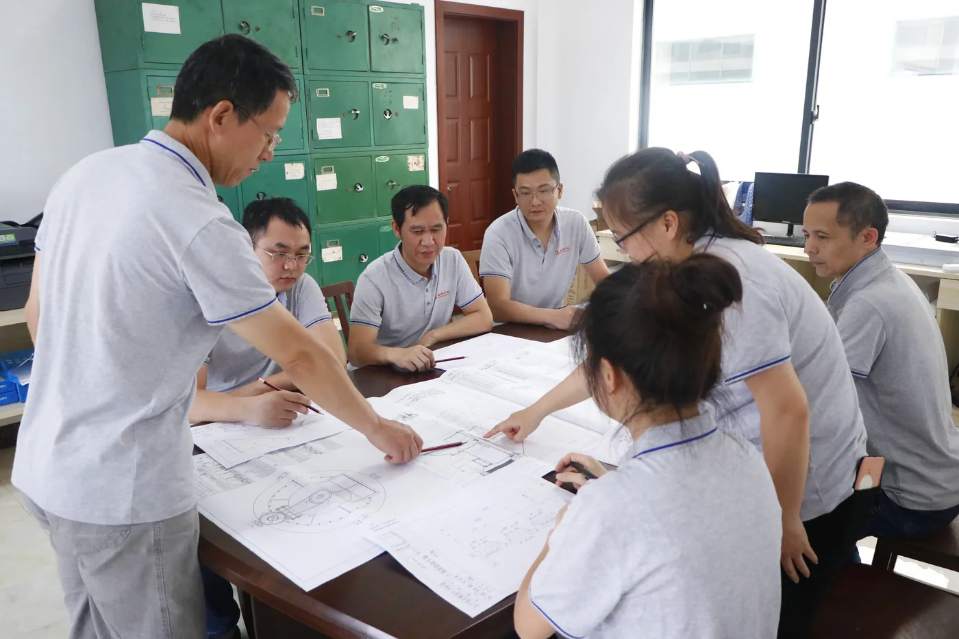 CRONUS engineers reviewing grinding mill drawings